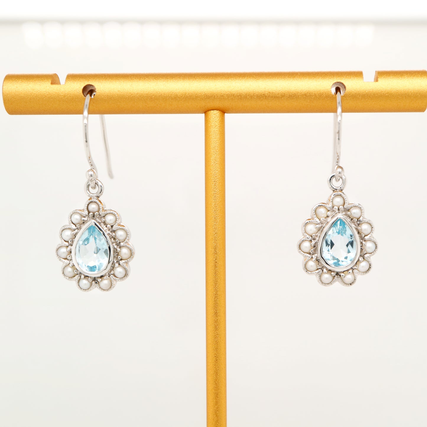 Colonial pearl and sky blue topaz droplet earrings in 9k white gold