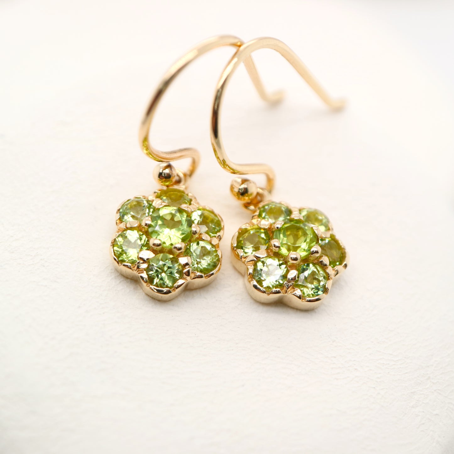 Daisy hook earrings with peridot in 9k yellow gold