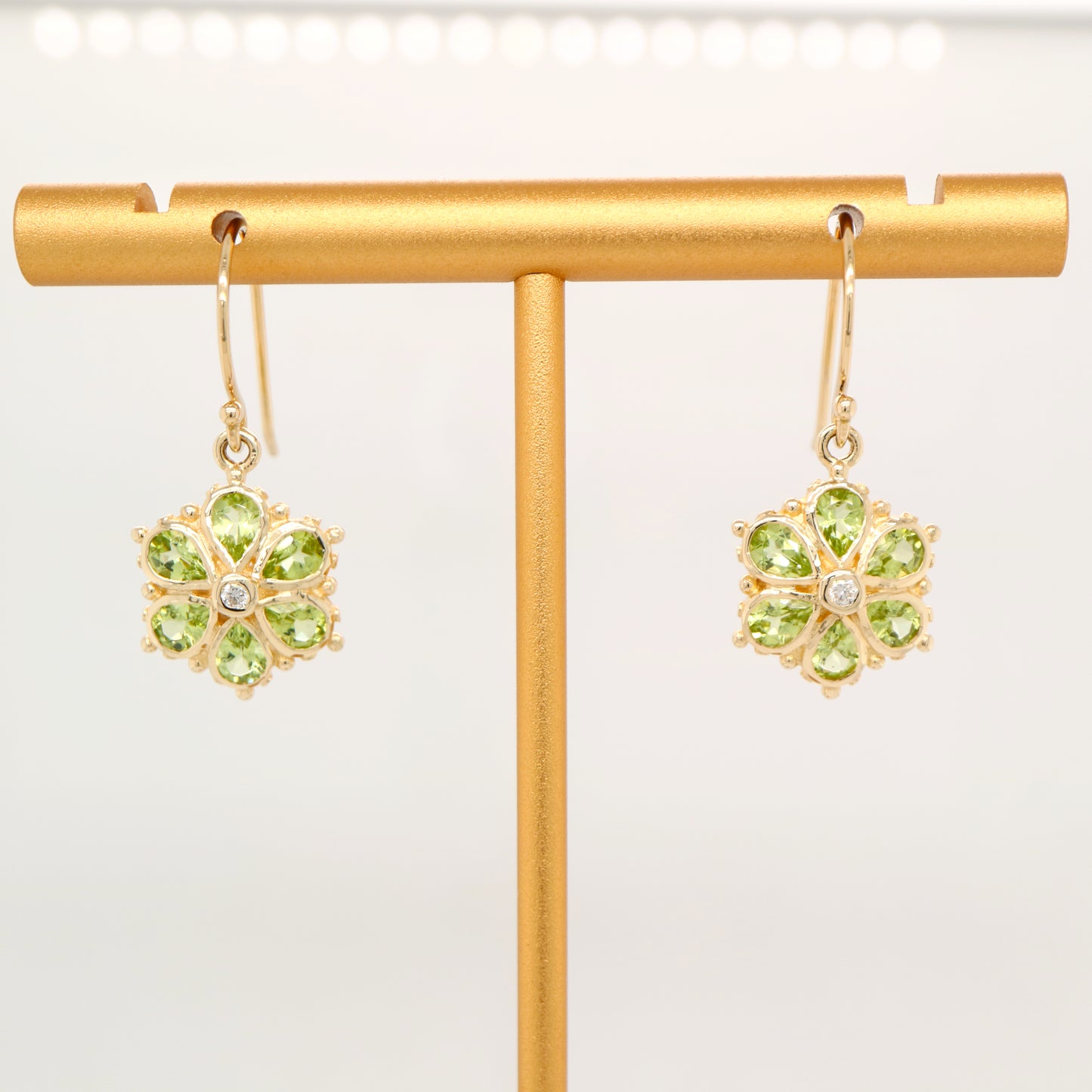 Peridot petal flower earrings with natural diamond in 9k yellow gold