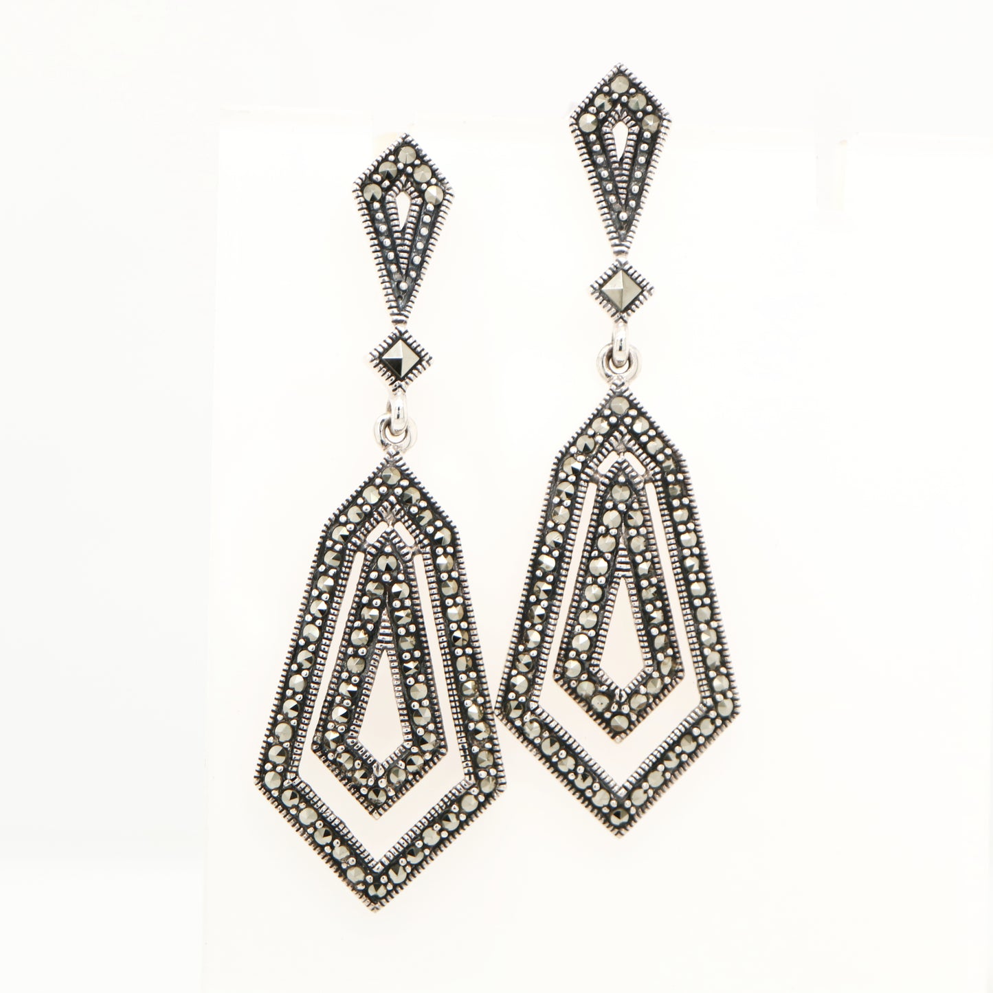 Pair of ornate earrings on a white background
