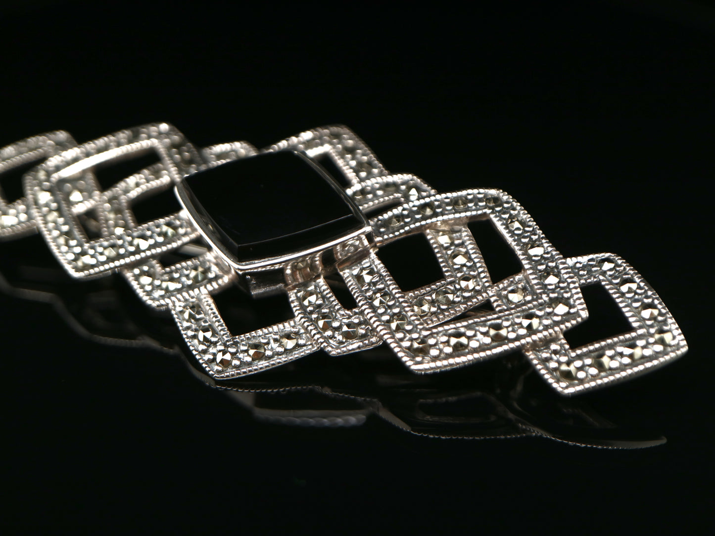Art deco tesselated brooch with marcasite and onyx in sterling silver