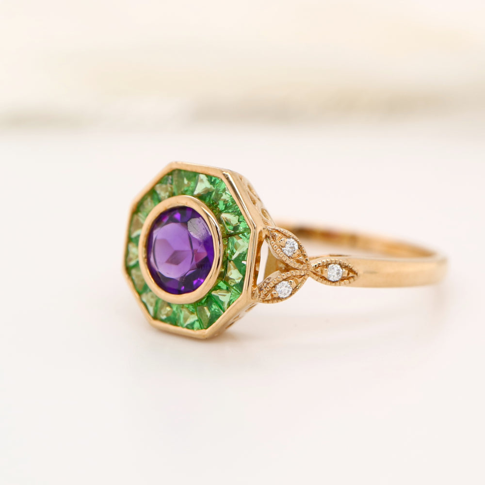 Target ring with channel set tsavorite garnet and amethyst with diamonds on the band in yellow gold