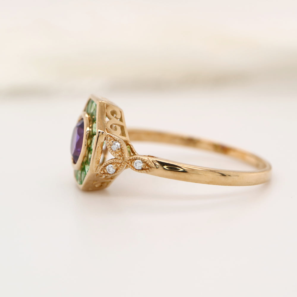 Target ring with channel set tsavorite garnet and amethyst with diamonds on the band in yellow gold