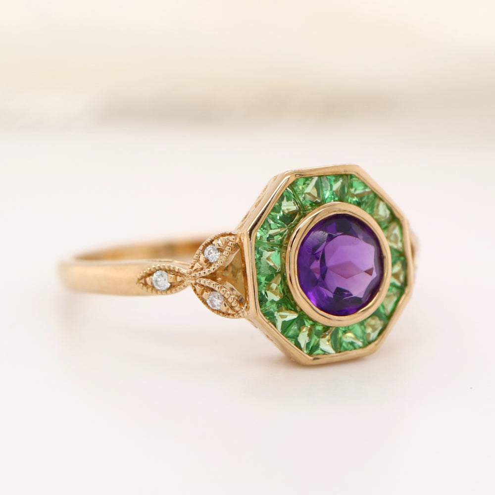 Target ring with channel set tsavorite garnet and amethyst with diamonds on the band in yellow gold