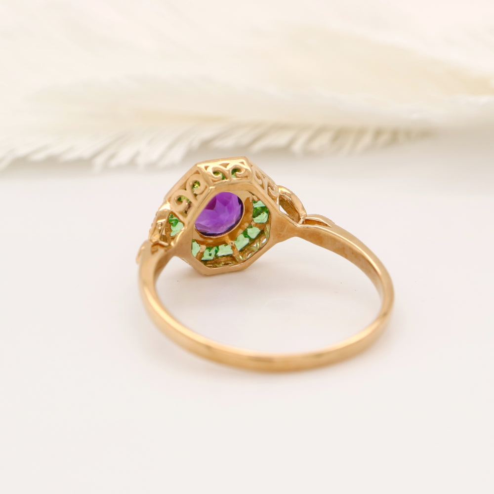 Target ring with channel set tsavorite garnet and amethyst with diamonds on the band in yellow gold