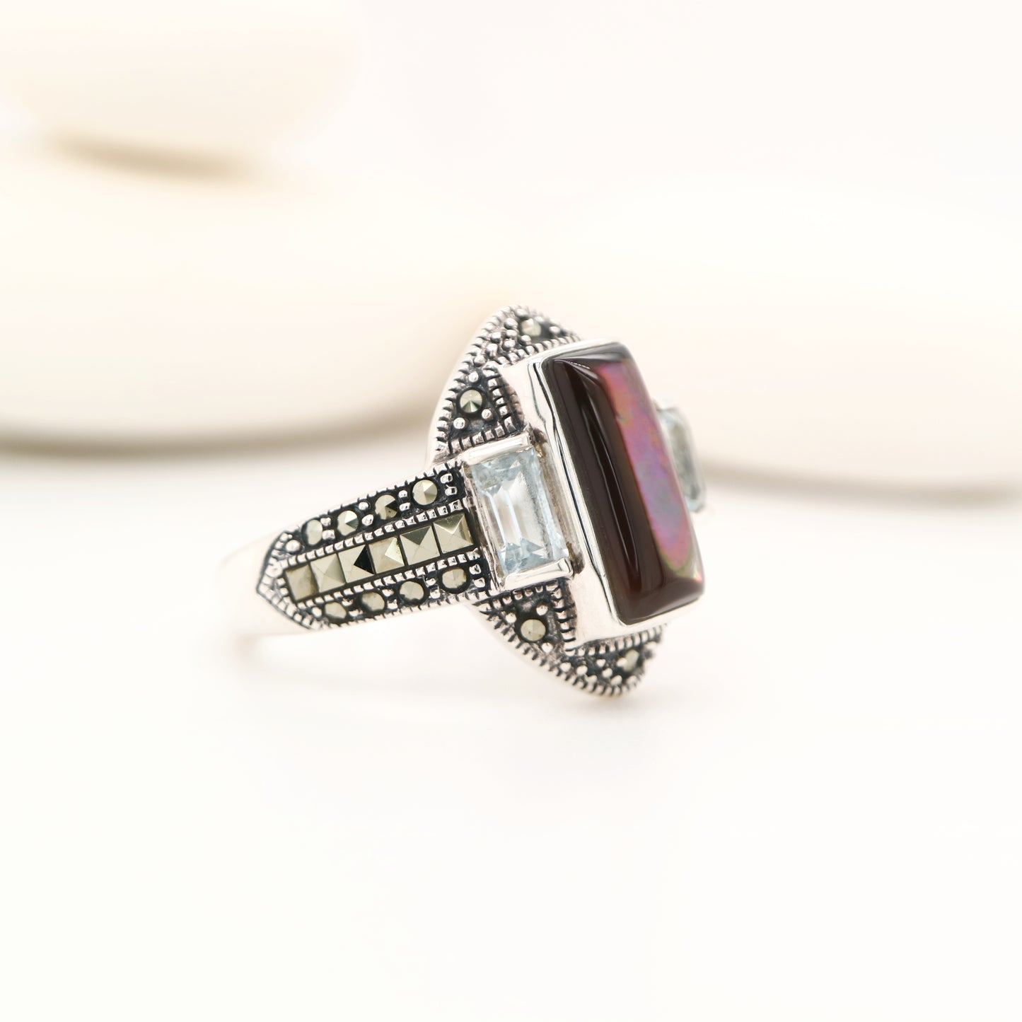 Silver lipped grey shell and pale blue topaz ring with marcasite and sterling silver