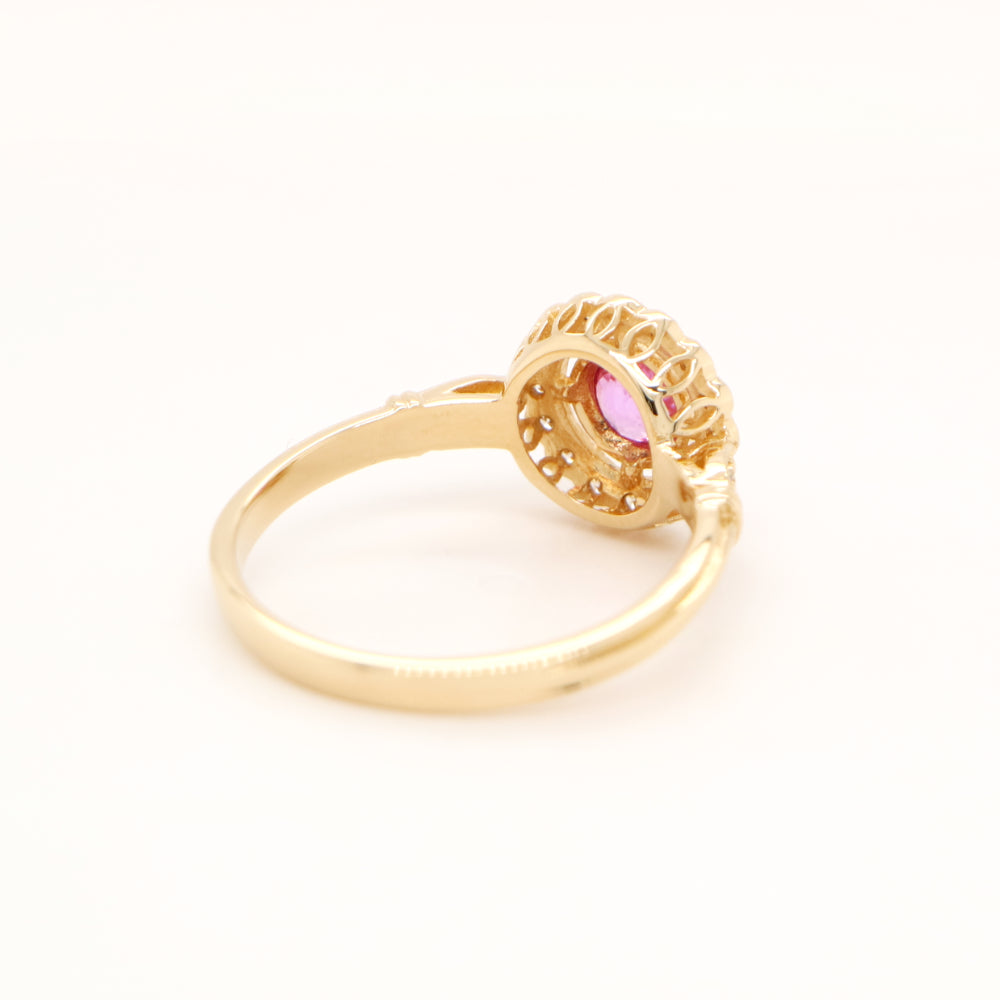 Pink sapphire with diamond halo in yellow gold ring