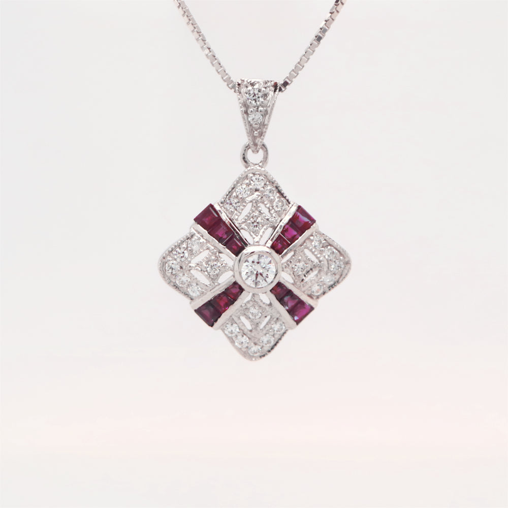 Art deco ruby and diamond pendant in cross over design set in 9k white gold
