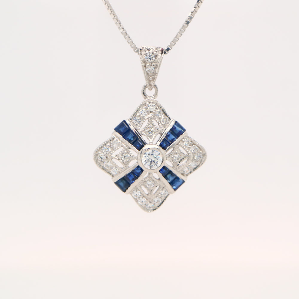 Art deco natural sapphire and diamond pendant in cross over design set in 9k white gold