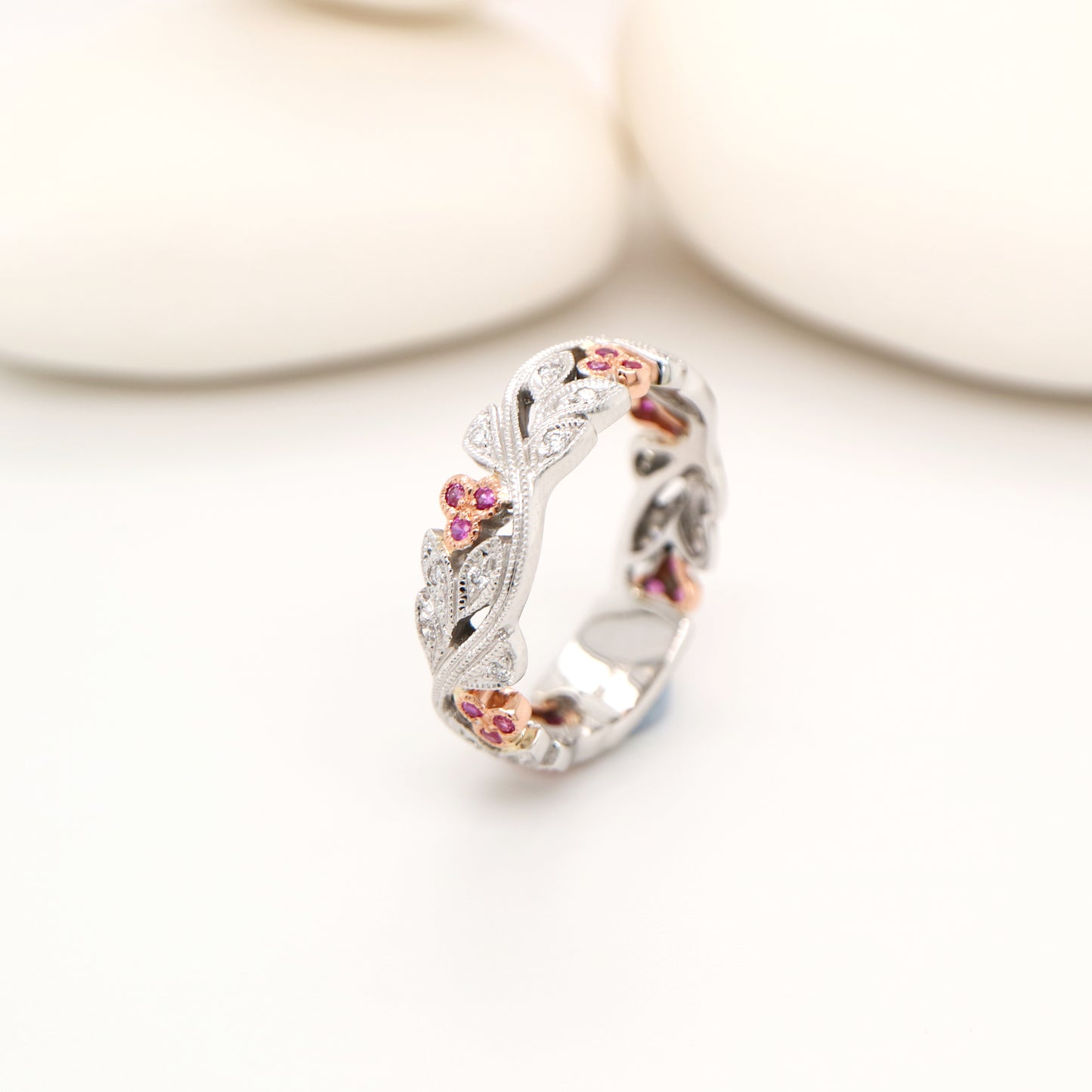 White gold vine and rose gold berries with pink sapphire and diamond