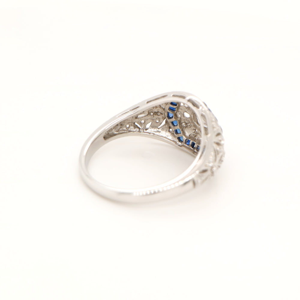 Art deco white gold ring with diamond and sapphire halo