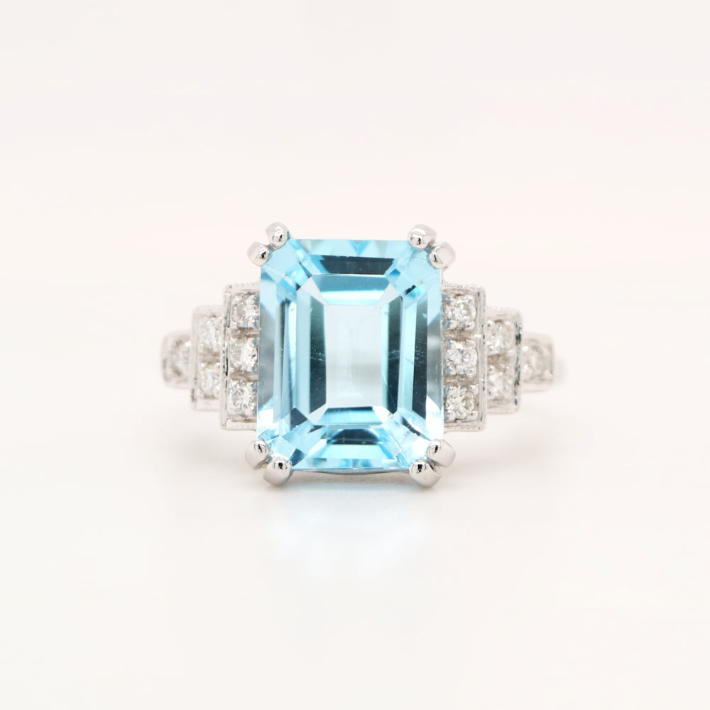 Blue topaz solitaire with diamonds in white gold