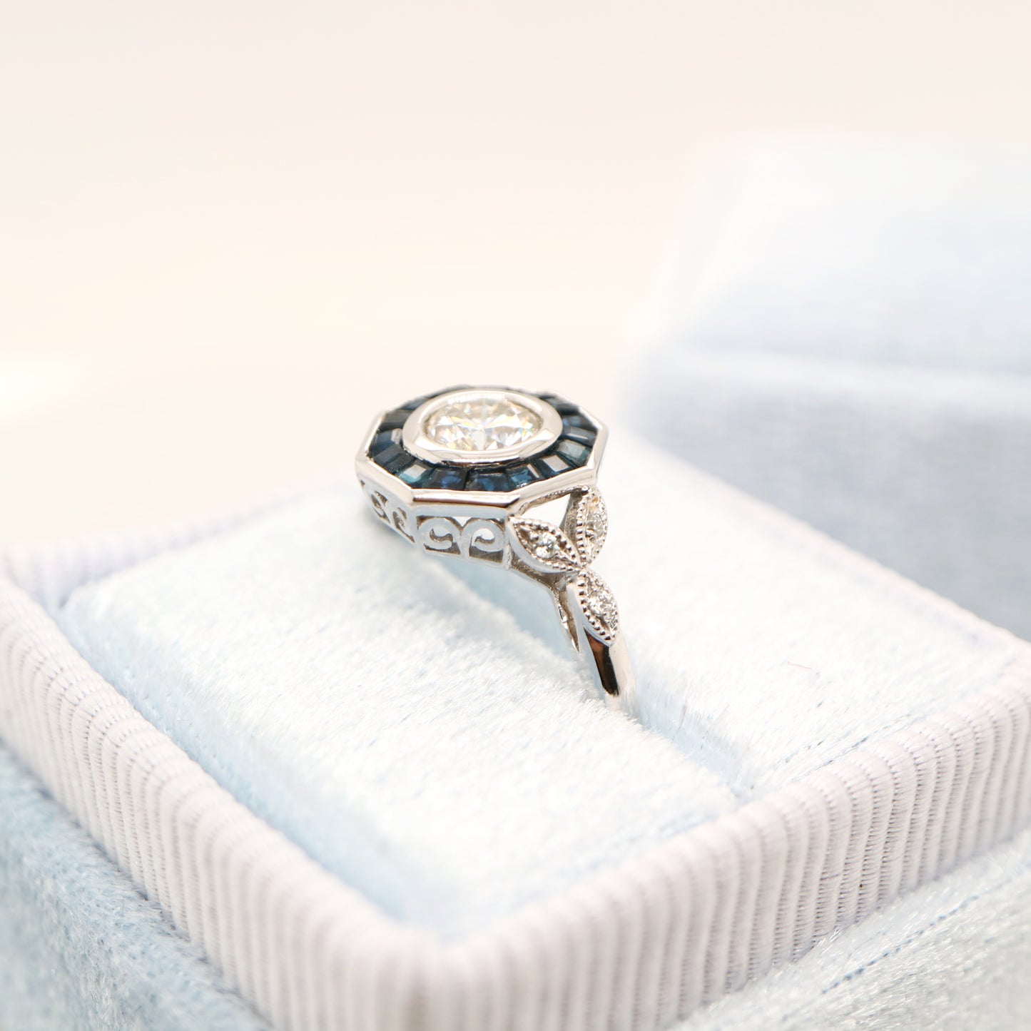 Target ring with channel set sapphires and moissanite in white gold