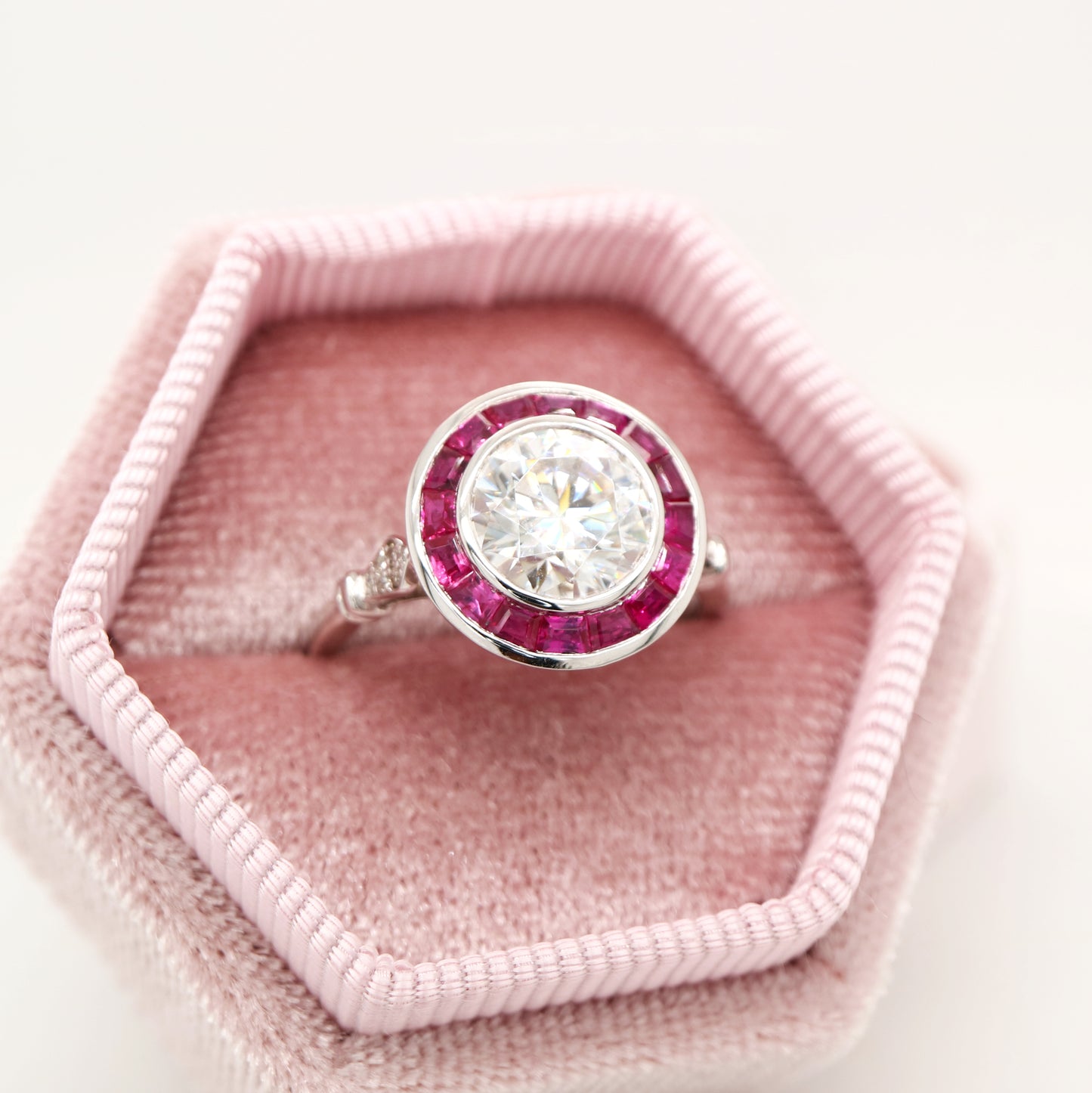 Moissanite with ruby halo ring in white gold
