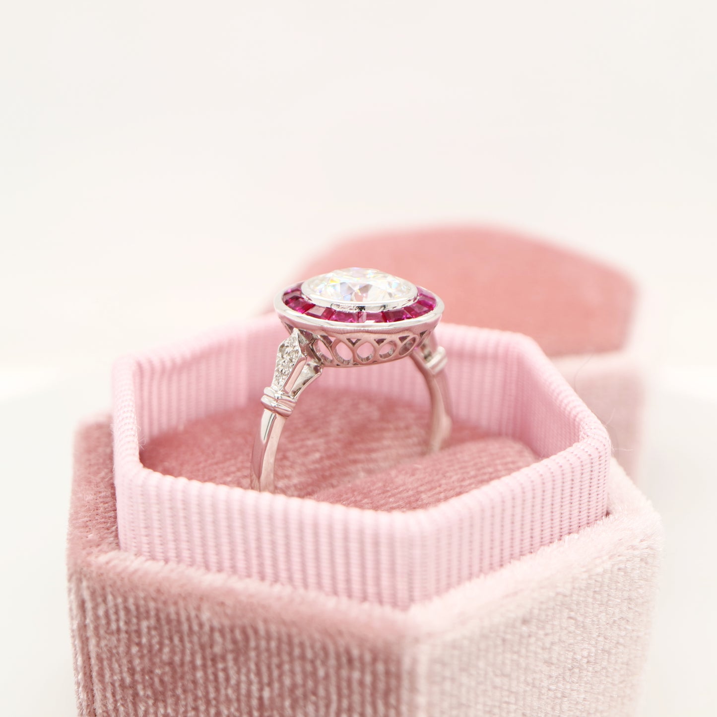 Moissanite with ruby halo ring in white gold