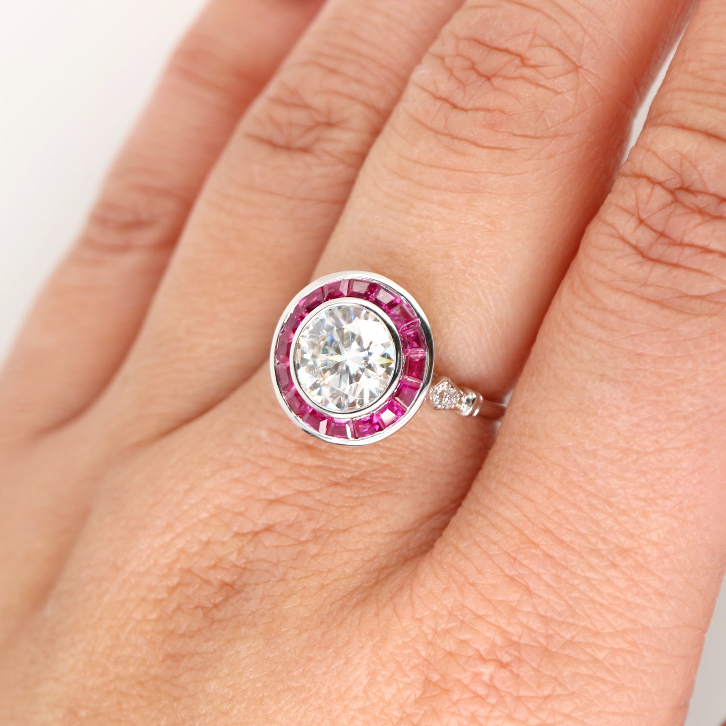Moissanite with ruby halo ring in white gold