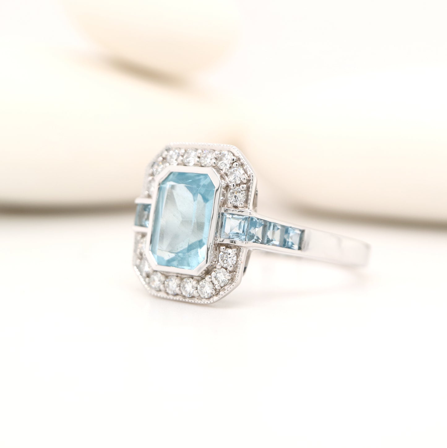 Aquamarine ring in gold with laboratory grown diamond halo
