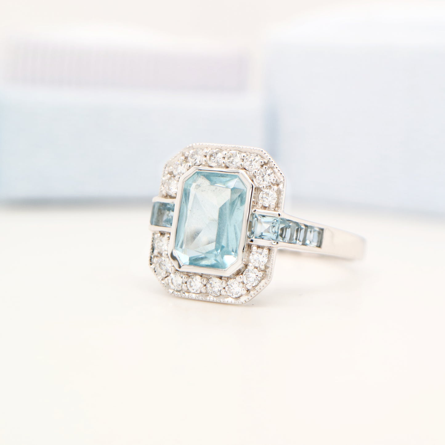 Aquamarine ring in gold with laboratory grown diamond halo