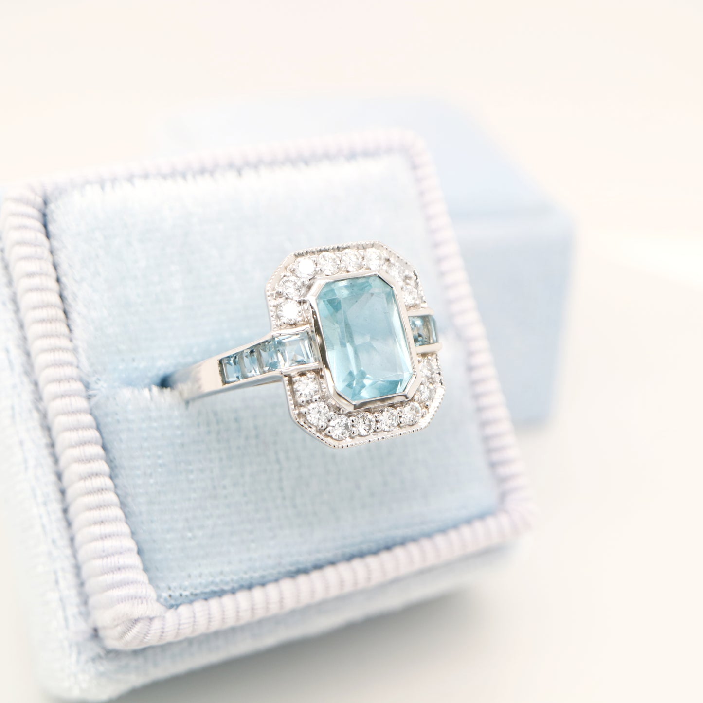 Aquamarine ring in gold with laboratory grown diamond halo