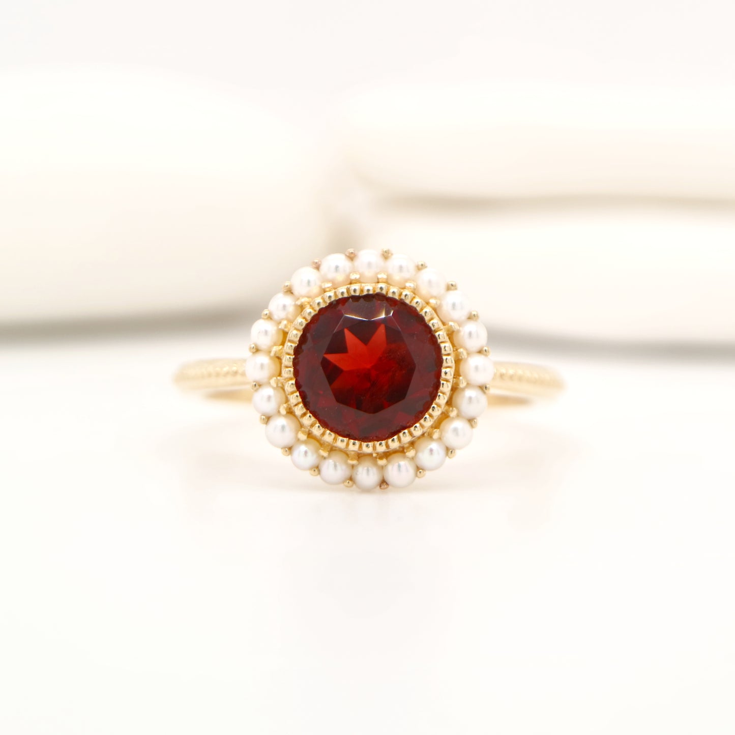 Colonial garnet filigree ring with pearl halo in yellow gold
