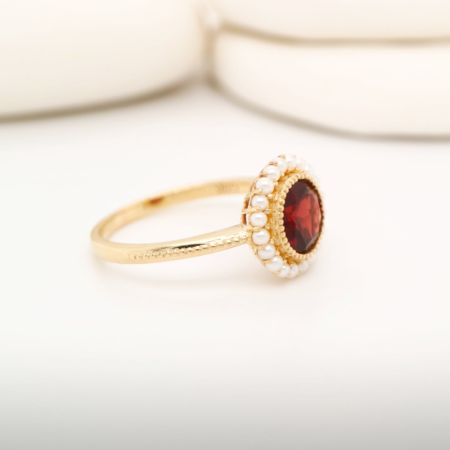 Colonial garnet filigree ring with pearl halo in yellow gold
