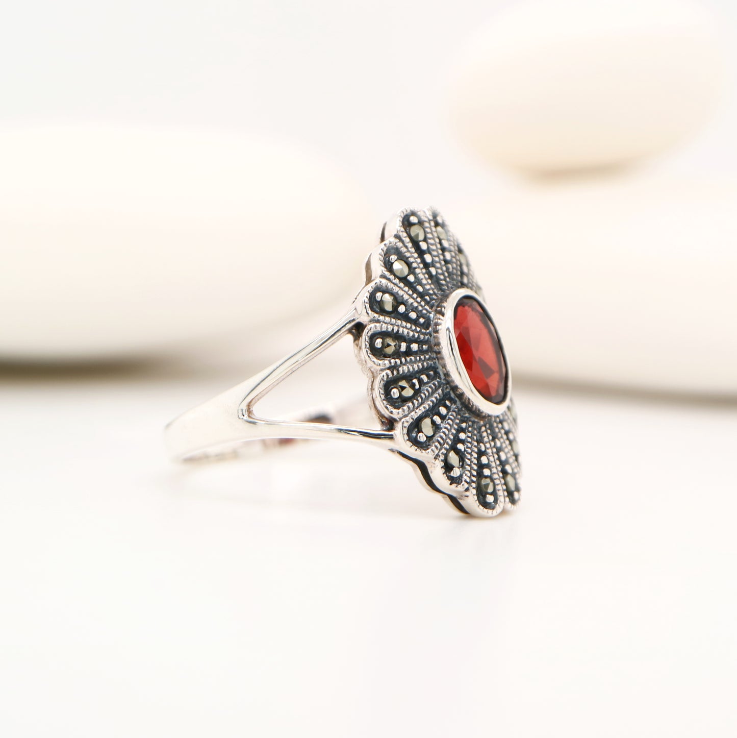 Marcasite shield with garnet ring in sterling silver