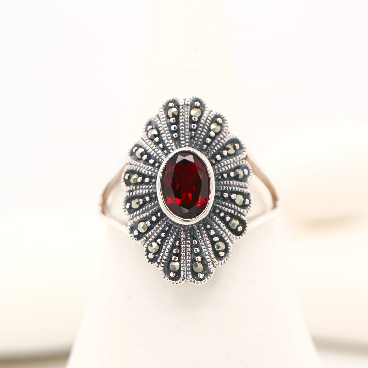 Marcasite shield with garnet ring in sterling silver