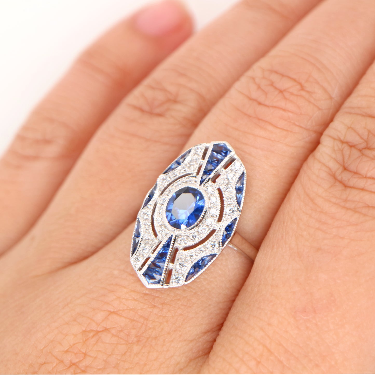 9k white gold shield ring with sapphire and diamond