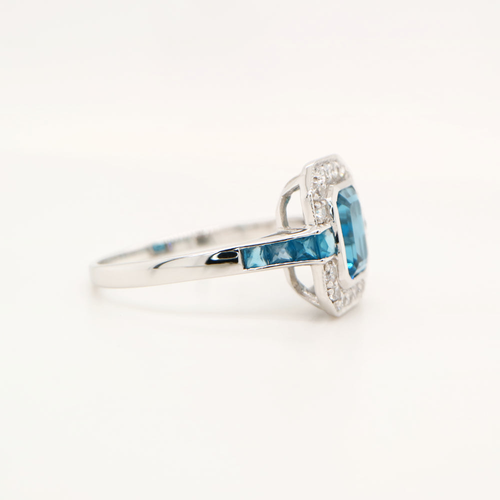 Vintage London blue topaz ring with diamond halo in white gold
