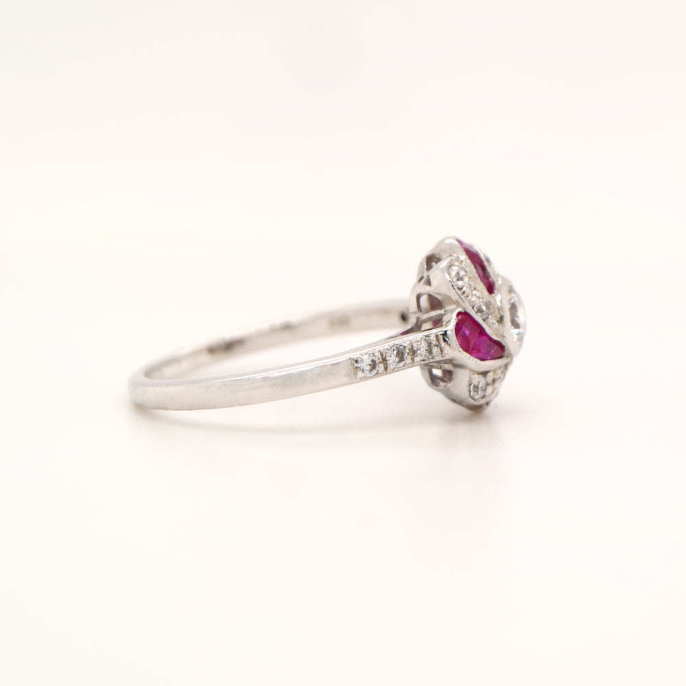 Silver ring with red gemstone on white background