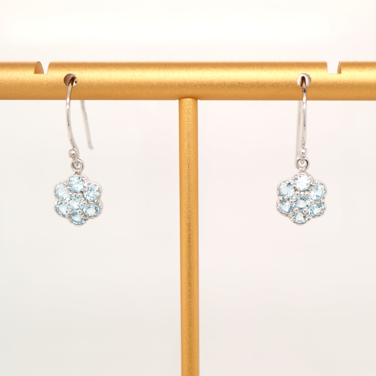 Daisy hook earrings with blue topaz in 9k White gold