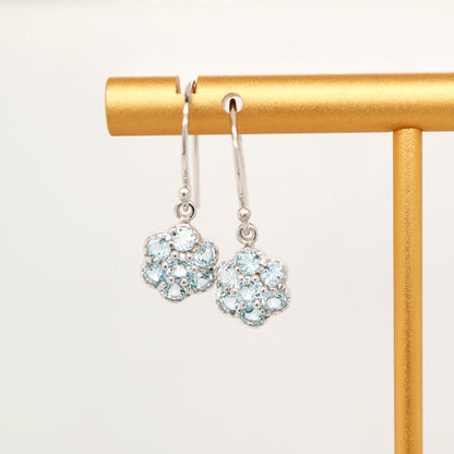 Daisy hook earrings with blue topaz in 9k White gold
