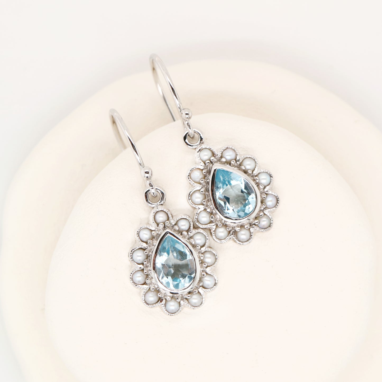 Colonial pearl and sky blue topaz droplet earrings in 9k white gold