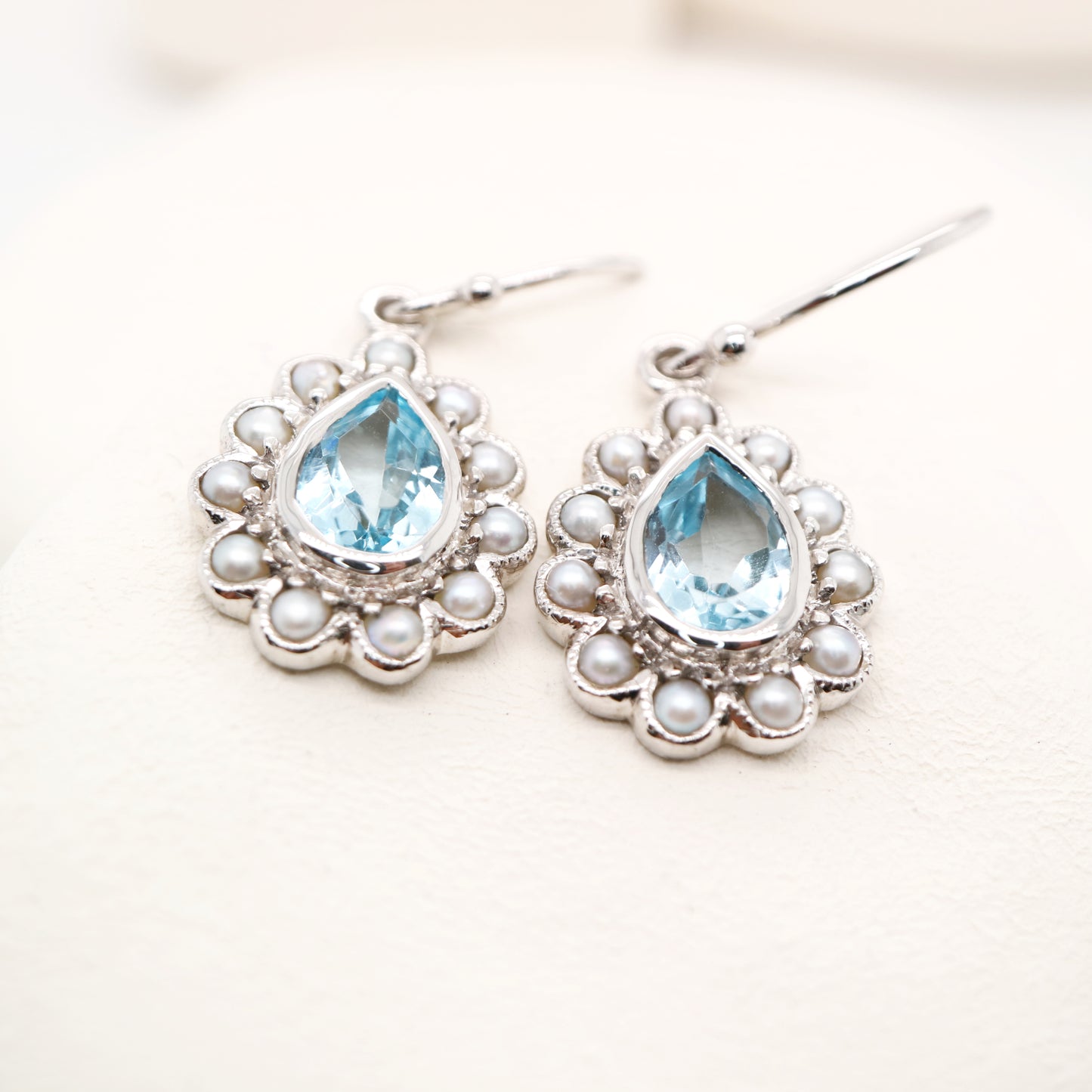 Colonial pearl and sky blue topaz droplet earrings in 9k white gold