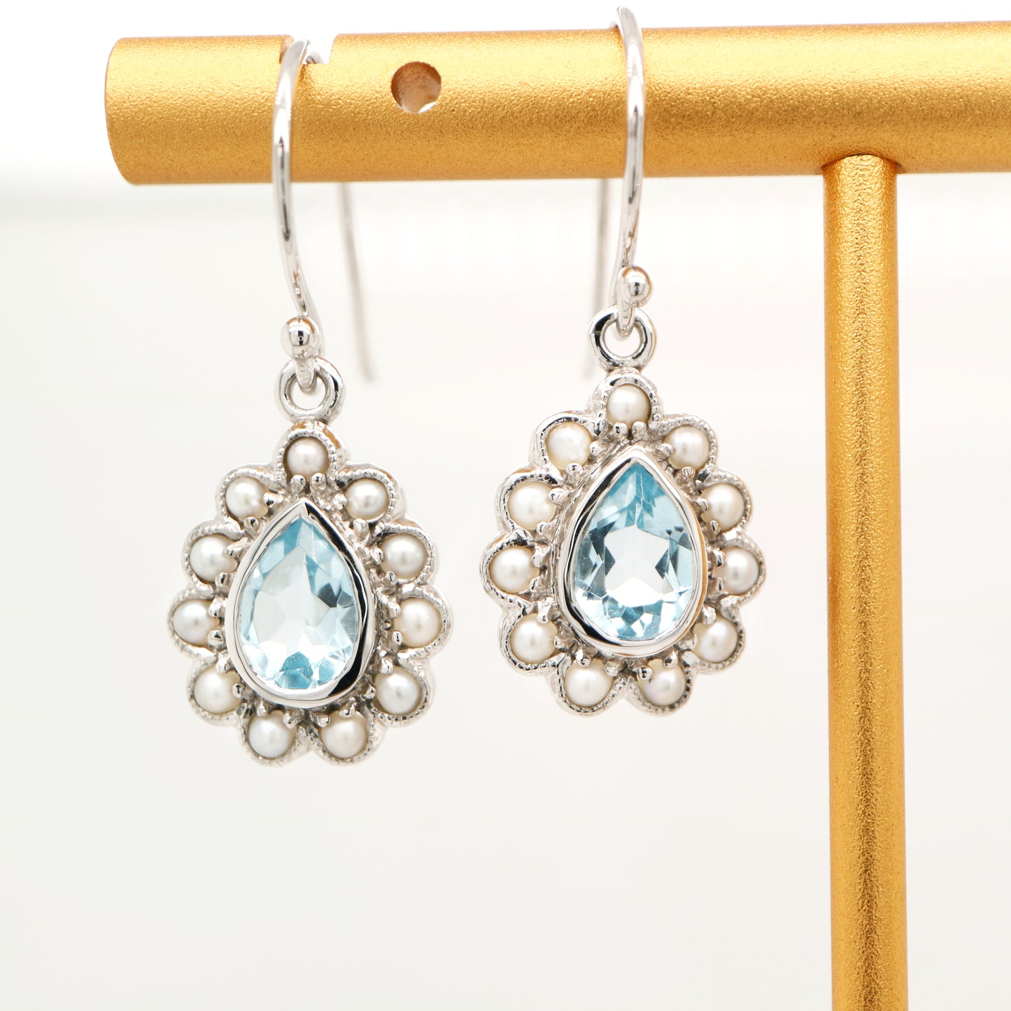 Colonial pearl and sky blue topaz droplet earrings in 9k white gold