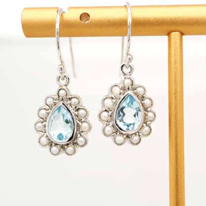 Colonial pearl and sky blue topaz droplet earrings in 9k white gold