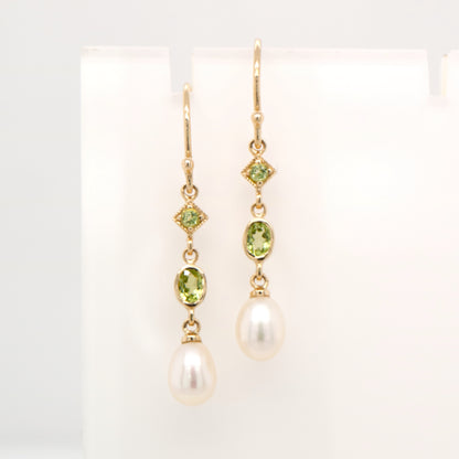 Hook dangle earrings with peridot and freshwater pearl drop in 9k yellow gold