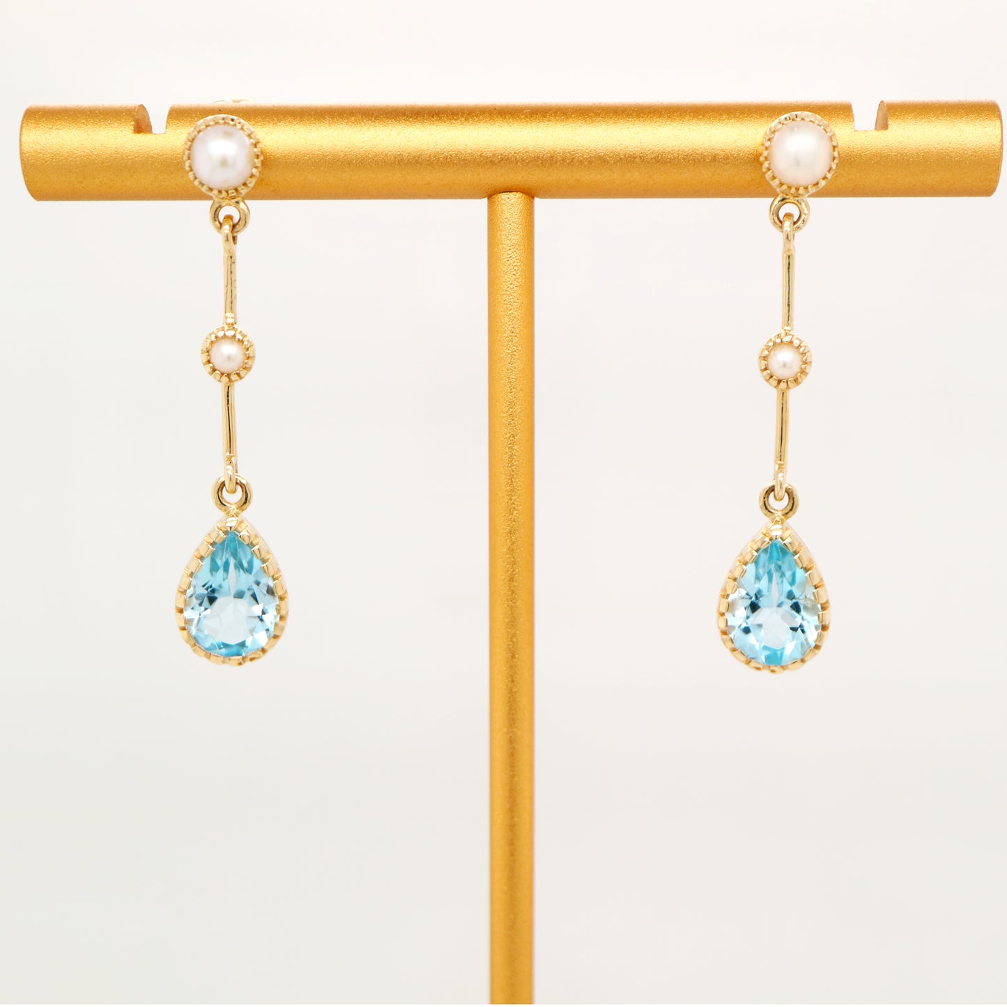 Freshwater pearl with blue topaz drop earrings in 9k yellow gold