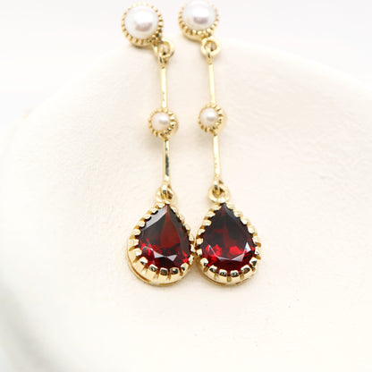Freshwater pearl with garnet drop earrings in 9k yellow gold