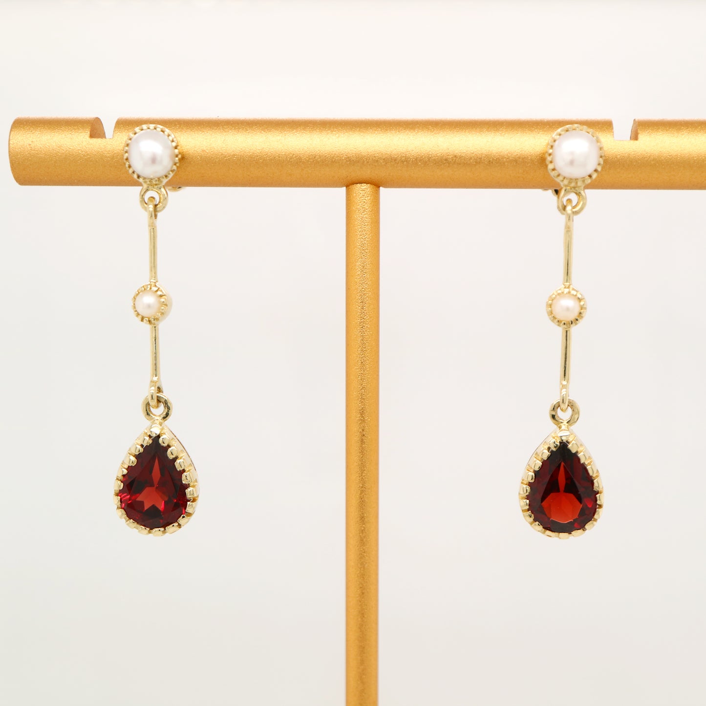 Freshwater pearl with garnet drop earrings in 9k yellow gold