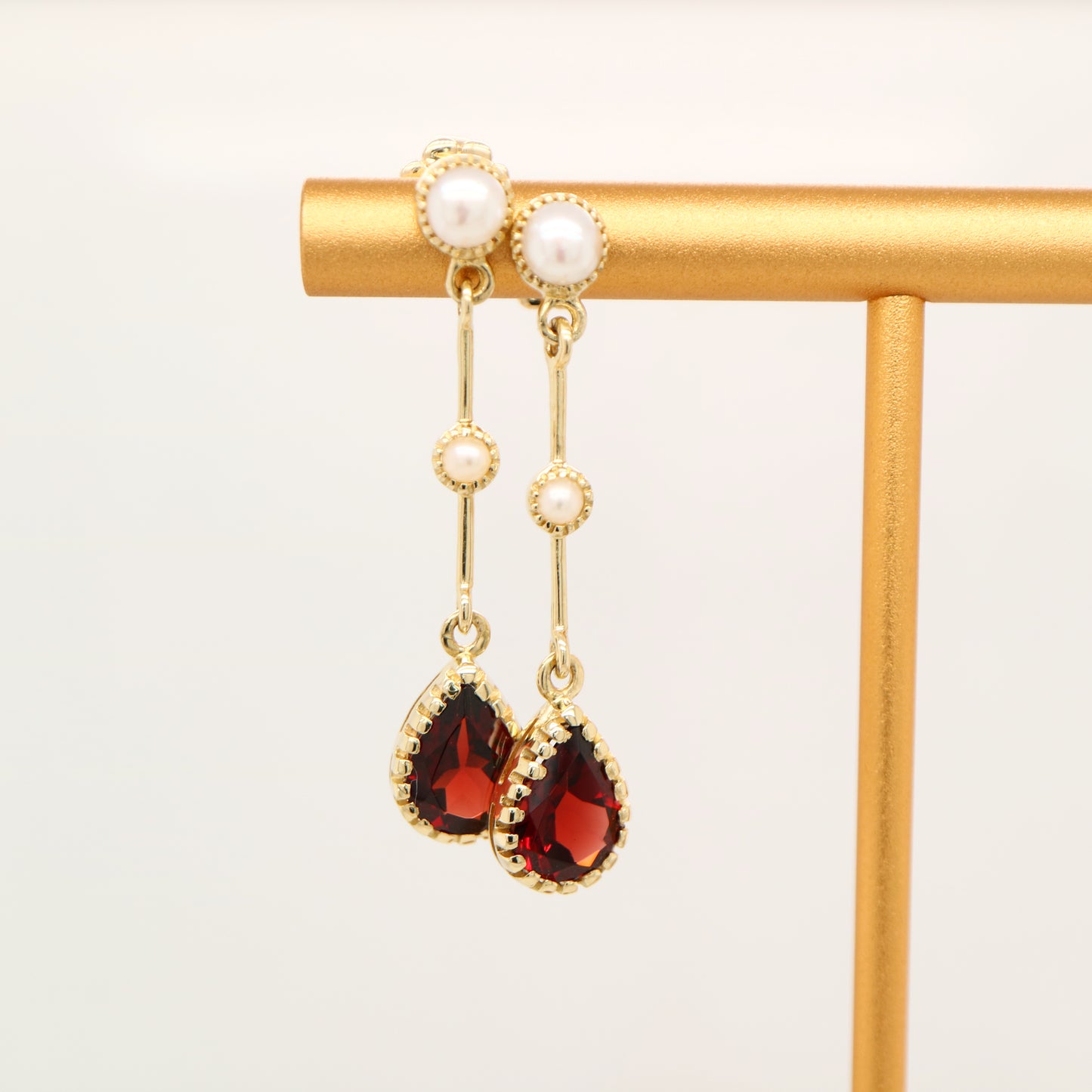 Freshwater pearl with garnet drop earrings in 9k yellow gold