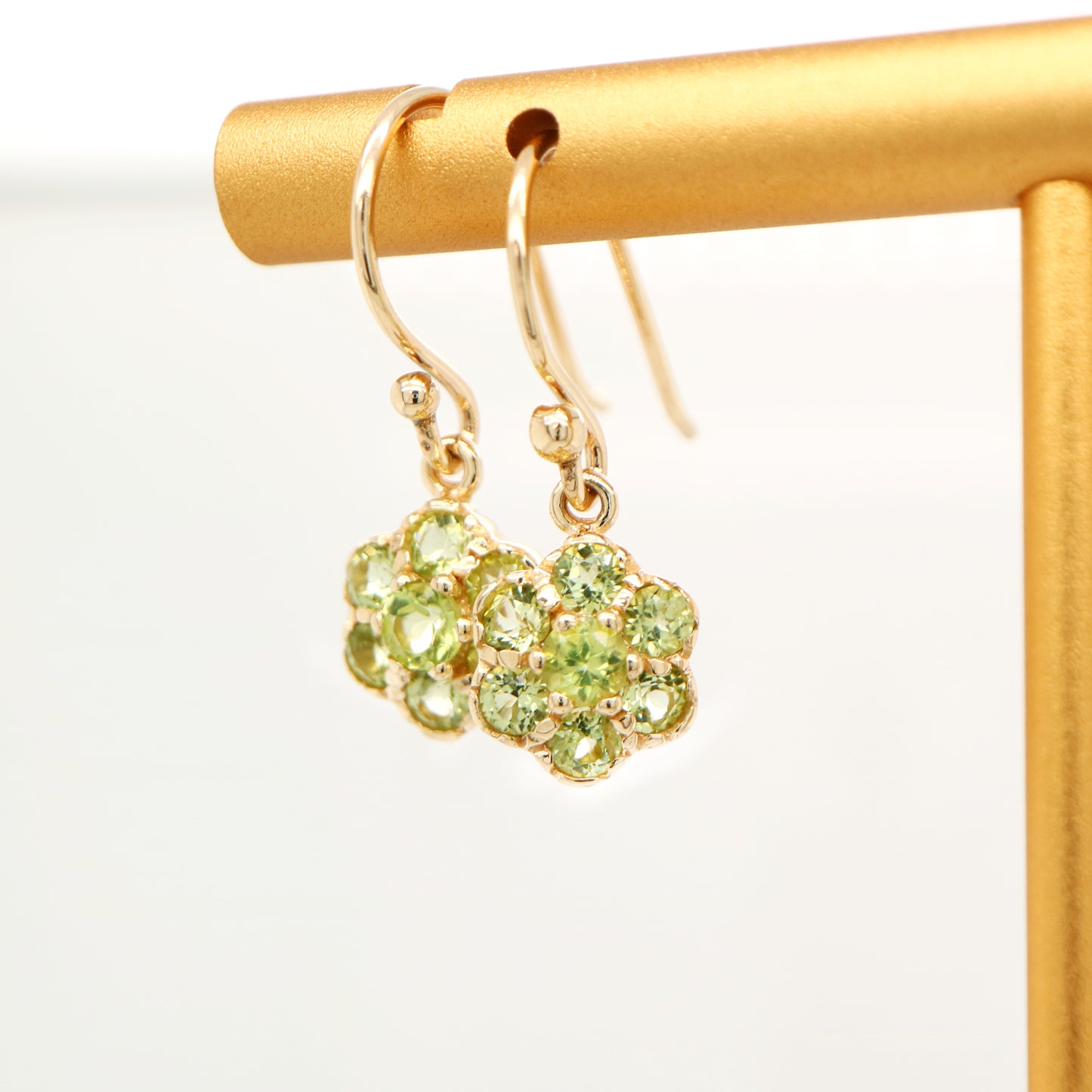 Daisy hook earrings with peridot in 9k yellow gold