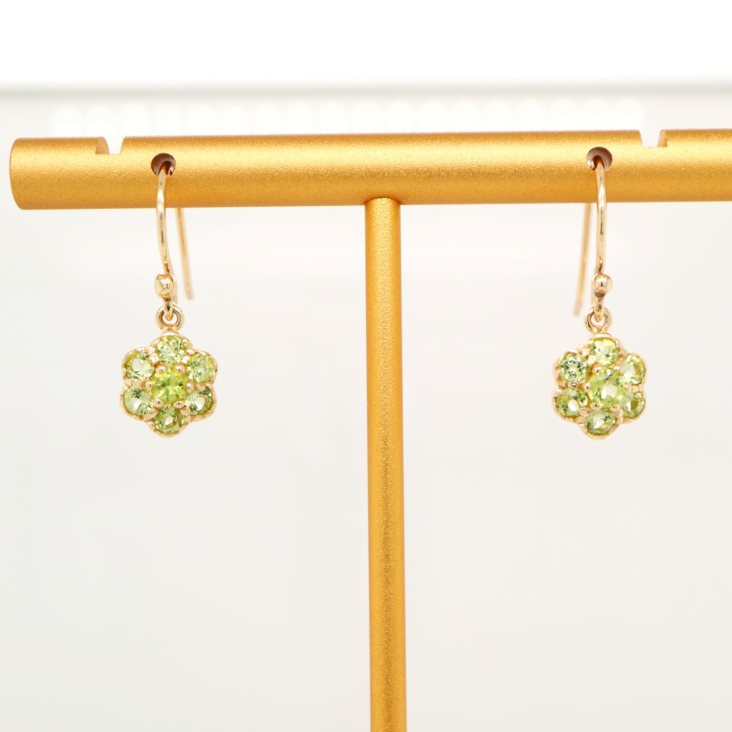 Daisy hook earrings with peridot in 9k yellow gold