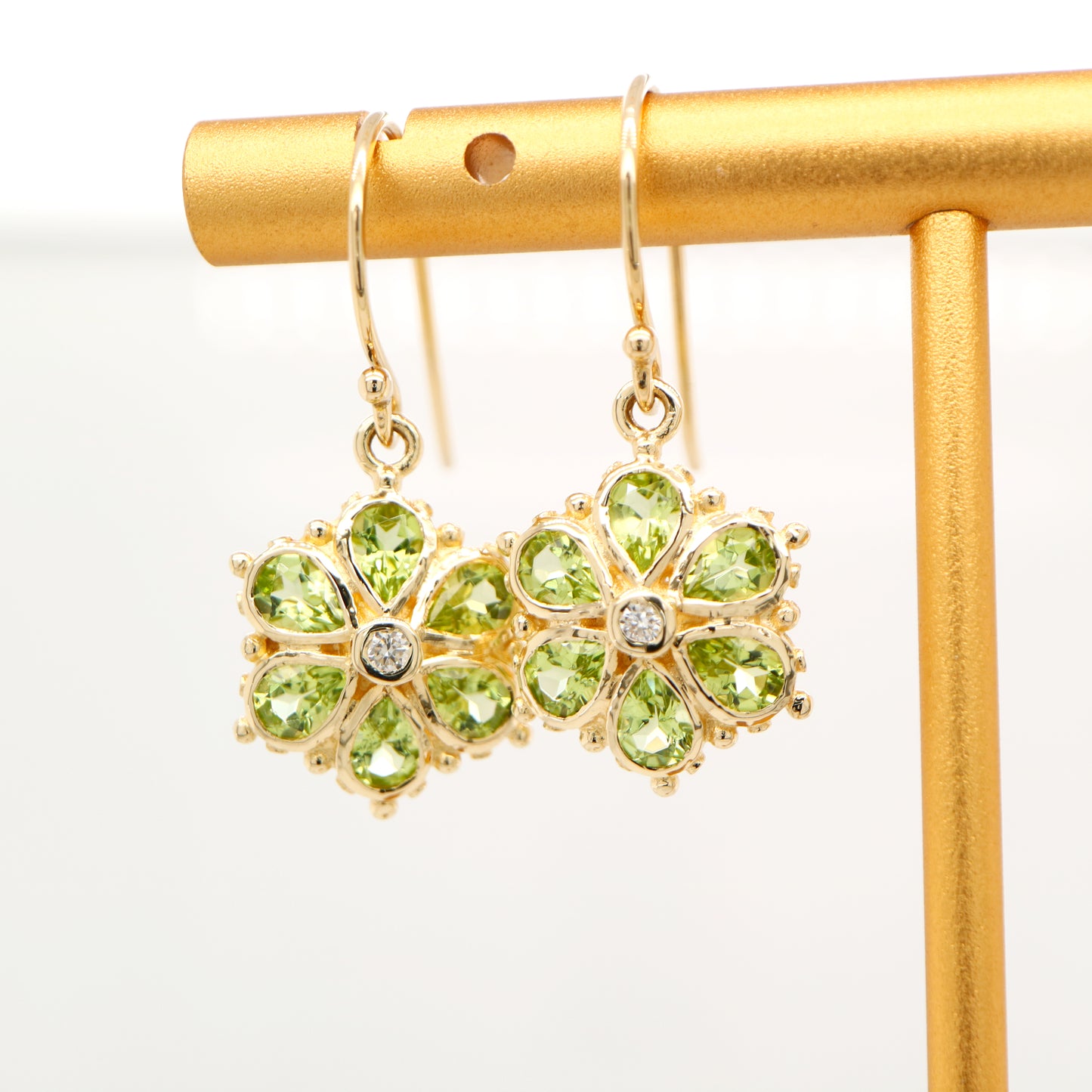 Peridot petal flower earrings with natural diamond in 9k yellow gold