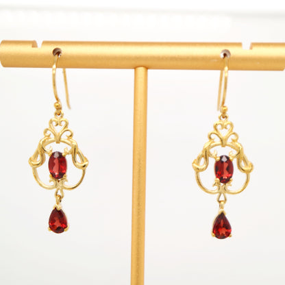 Art nouveau style earrings with garnet in 9k yellow gold