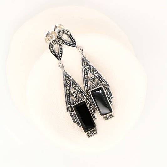Black and silver earrings on a white background