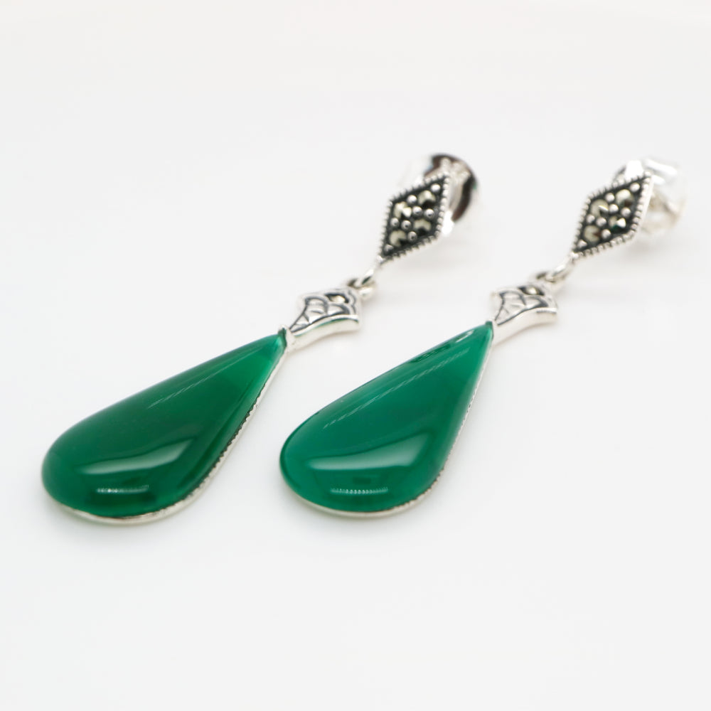 Green teardrop earrings with silver accents on a white background