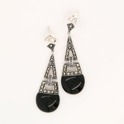 Pair of black and silver earrings on a white background