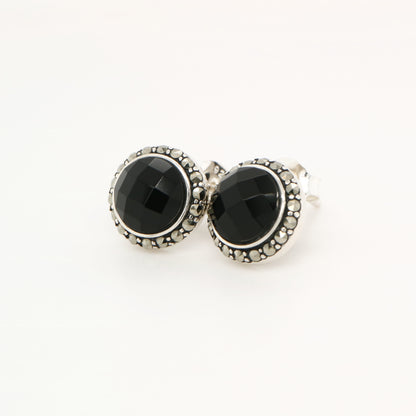 Pair of black gemstone earrings with silver accents on a white background