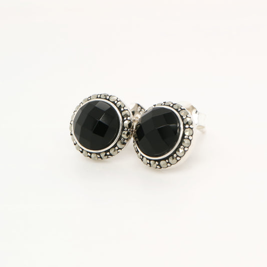 Pair of black gemstone earrings with silver accents on a white background